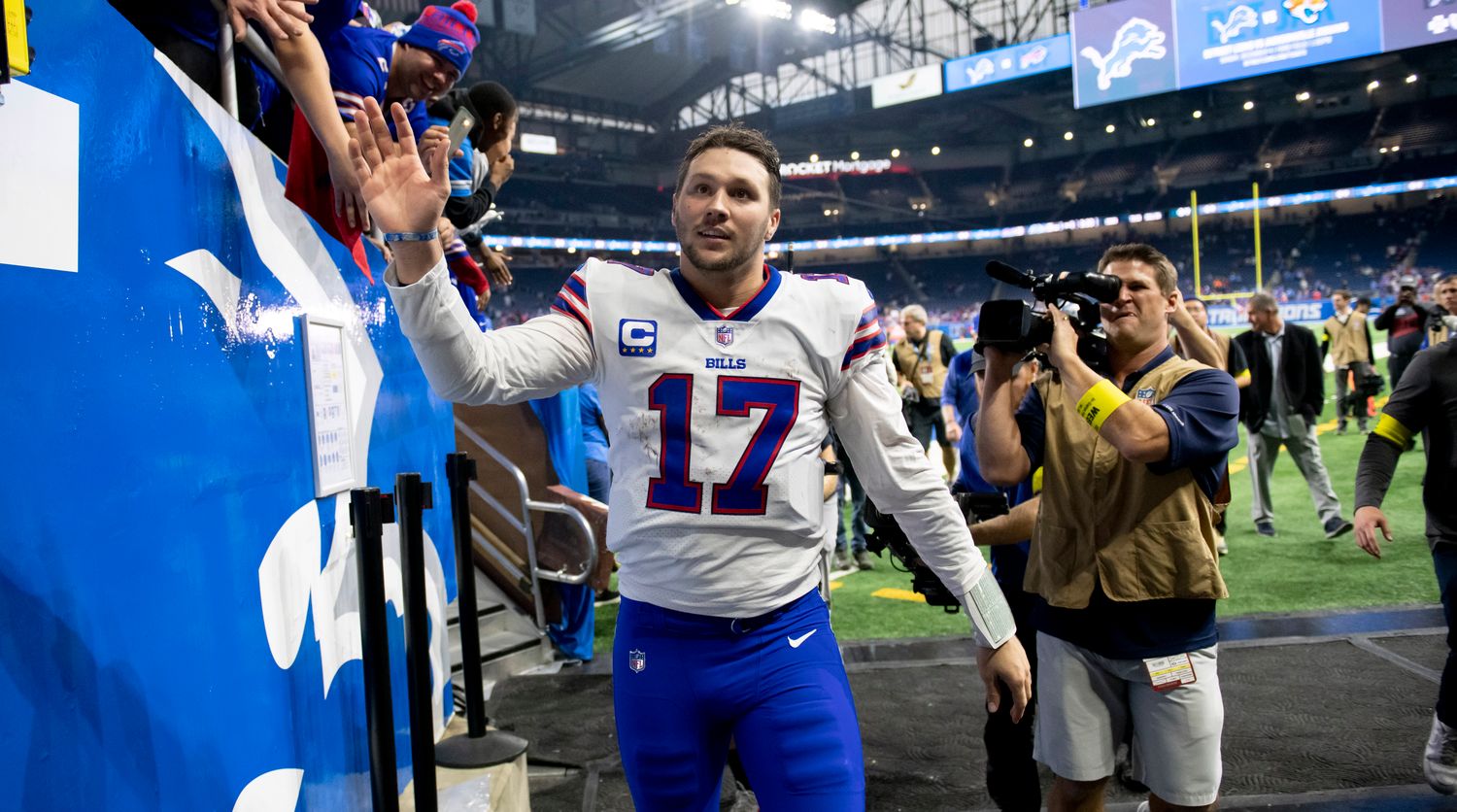 Josh Allen high fives fans as he walks off the field